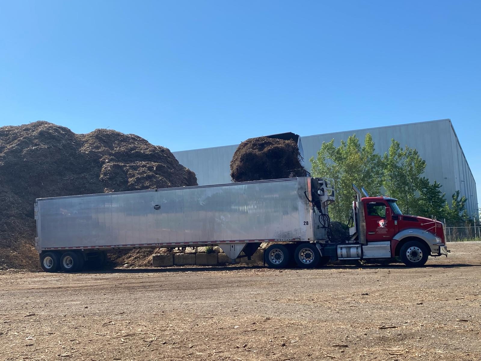 Pijuy truck hauling a full trailer load of wood chips